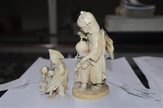 A Meiji carved ivory group of two children (damaged) on hardwood stand and a smaller group tallest 14cm incl. stand